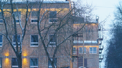 Small town Ramenskoe in Moscow region view in winter cold sunset. Old buildings of  a former textile factory.  Blizzard. Natural background.