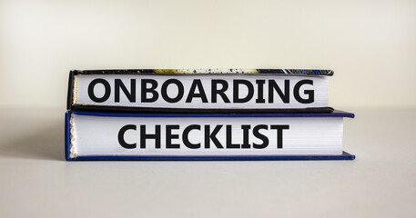 Onboarding checklist symbol. Books with words 'onboarding checklist' on beautiful white background....