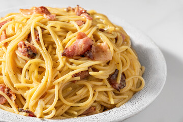 Classic homemade carbonara pasta with pancetta, egg, parmesan cheese and cream sauce. Italian food