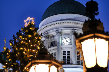 Old Clock on the Dome of Helsinki Cathedral, Finland. In the foreground the Christmas tree and the...