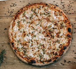 Seafood Italian pizza with shrimp,squid, mussels, fresh herbs and mozzarella. Pizza with seafood, mussels, squid and shrimps with cheese and herbs