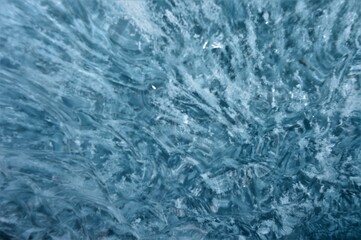 Pressed clear blue glacier ice with air bubbles and shapes 