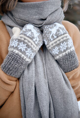 Fototapeta na wymiar Hands in Knitted Mittens. Winter lifestyle. Wearing Stylish Warm
