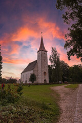 Amazing sunrise sky over high rural church in Suure-Jaani, Estonia.