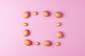 Easter eggs on pink background. Flat lay, copy space.