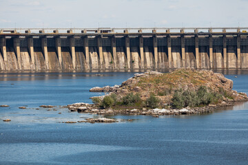 Fototapeta na wymiar Industrial landscape. Powerful concrete dam blocks river