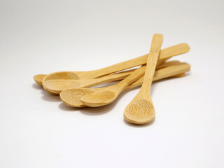 Bamboo spoons. Ecological wooden spoons. Kitchen utensils. Caring for the planet. Elements of renewable, natural and ecological material. Isolated.