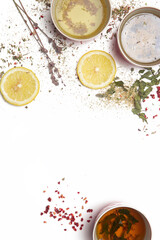 Herbal tea, top view with copy spce. Dry herbs, lemon slices and tea cups on white. Herbs in bulk, zero waste and eco-friendly lifestyle, herbal medicine concept.	