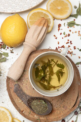 Herbal tea, top view. Dry herbs, lemon slices and tea cups on white. Herbs in bulk, zero waste and eco-friendly lifestyle, herbal medicine concept.	