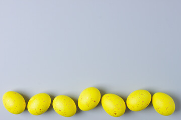 Easter yellow eggs on grey background. Flat lay, copy space.