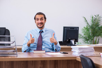 Young male employee working in the office