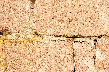 Texture of a brick wall with cracks and scratches which can be used as a background