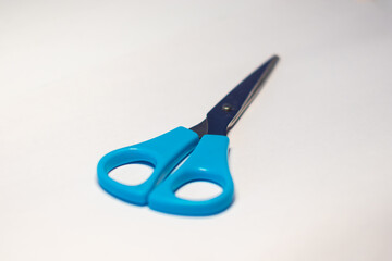 scissors with blue handles on a white background
