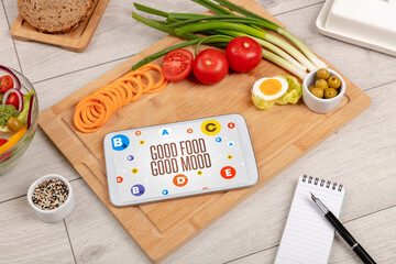 Healthy Tablet Pc compostion with GOOD FOOD GOOD MOOD inscription, weight loss concept