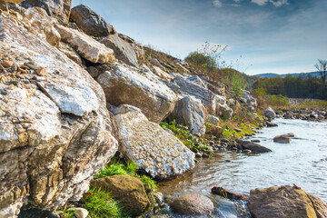 Rough mountain river with rocky shores, original rock configuration on the banks of the river,...