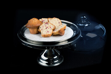 cranberry muffins on a stainess steel cake tray isolated on black