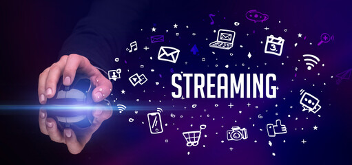 hand holding wireless peripheral with STREAMING inscription, social media concept