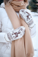 Hands in Knitted Mittens. Winter lifestyle. Wearing Stylish Warm