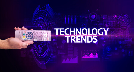 hand holding wireless peripheral with TECHNOLOGY TRENDS inscription, modern technology concept