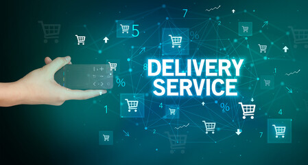 hand holding wireless peripheral with DELIVERY SERVICE inscription, online shopping concept