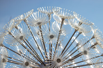 abstract beautiful background of light decaration in form of umbrellas on the blue sky