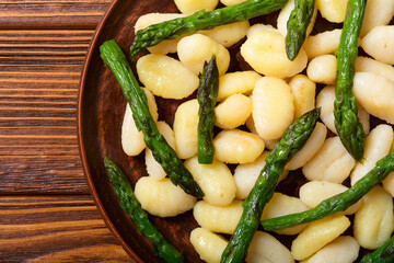 Italian homemade potatoes gnocchi with asparagus