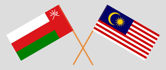 Crossed flags of Oman and Malaysia. Official colors. Correct proportion