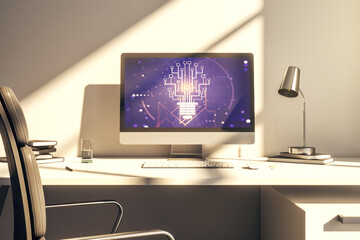 Modern computer monitor with creative light bulb hologram and chip on laptop background, idea and brainstorming concept. 3D Rendering