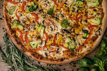 Vegetable pizza with bell peppers and broccoli and mushrooms