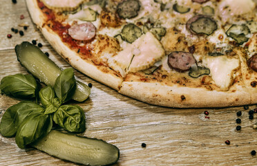 Super cheesy pizza with hunting sausages, pickles and melted cheese