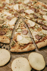 Super cheesy pizza with hunting sausages, pickles and melted cheese