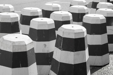 Striped black and white concrete anti-parking cones for roadworks, Road safety. Parking curbstone