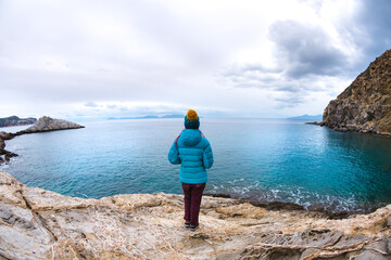 Girl looks at the beautiful winter sea