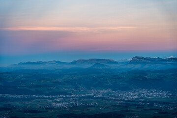 Fototapeta premium swiss mountains during sunset with fog and clouds and snowy mountains in the alps