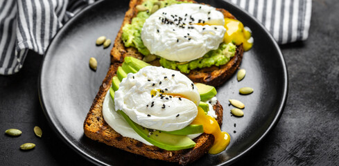 Sandwich with avocado and Poached Egg. Wholemeal Bread Toast sliced avocado and egg. healthy breakfast or snack, top view