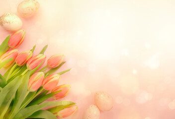 Spring Easter composition with pink tulips flowers and eggs on pastel background. Bannner top view, copy space