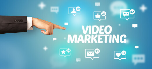Close-Up of cropped hand pointing at VIDEO MARKETING inscription, social networking concept
