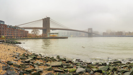 Brooklyn bridge at foggy rainy day, New York City