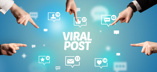 Close-Up of cropped hand pointing at VIRAL POST inscription, social networking concept