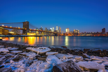 Brooklyn bridge East river and Manhattan at winter dawn, New York City