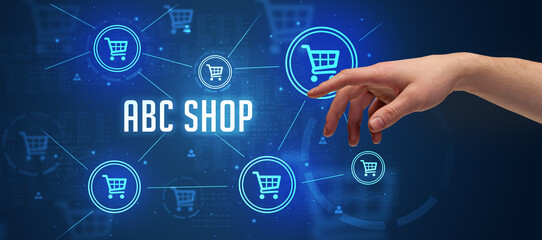 Close-Up of cropped hand pointing at ABC SHOP inscription, online shopping concept