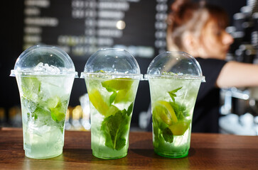 Bartender making mojito cocktail. Process of bartending in bar
