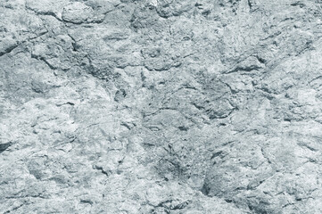 Stone background of light gray slate,  texture of sheer cliff
