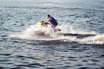 Man speeding on jet ski on lake during summer vacation