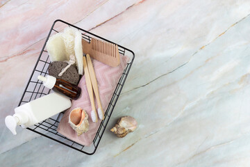 self-care kit for body, hair, face, shower accessories in a basket on a marble background. concept zero waste, sustainable. copy space. flat lay