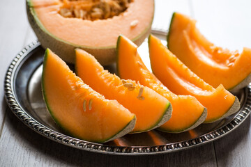 Fototapeta na wymiar ripe melon cut into pieces on a platter