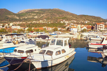 Fototapeta na wymiar Fishing boats in harbor. Montenegro, Tivat city, view of marina Kalimanj