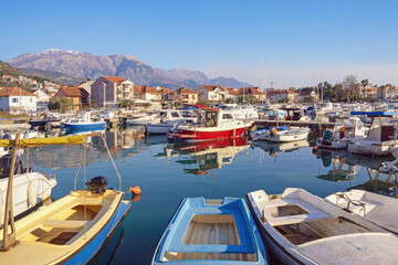 Fototapeta na wymiar Beautiful Mediterranean landscape. Fishing boats in harbor. Montenegro, Kotor Bay, Tivat city, view of marina Kalimanj