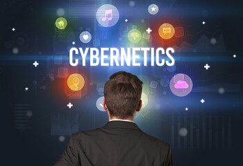 Rear view of a businessman with CYBERNETICS inscription, modern technology concept