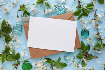 postcard mockup. floral frame of spring flowers, envelope and white blank for text 